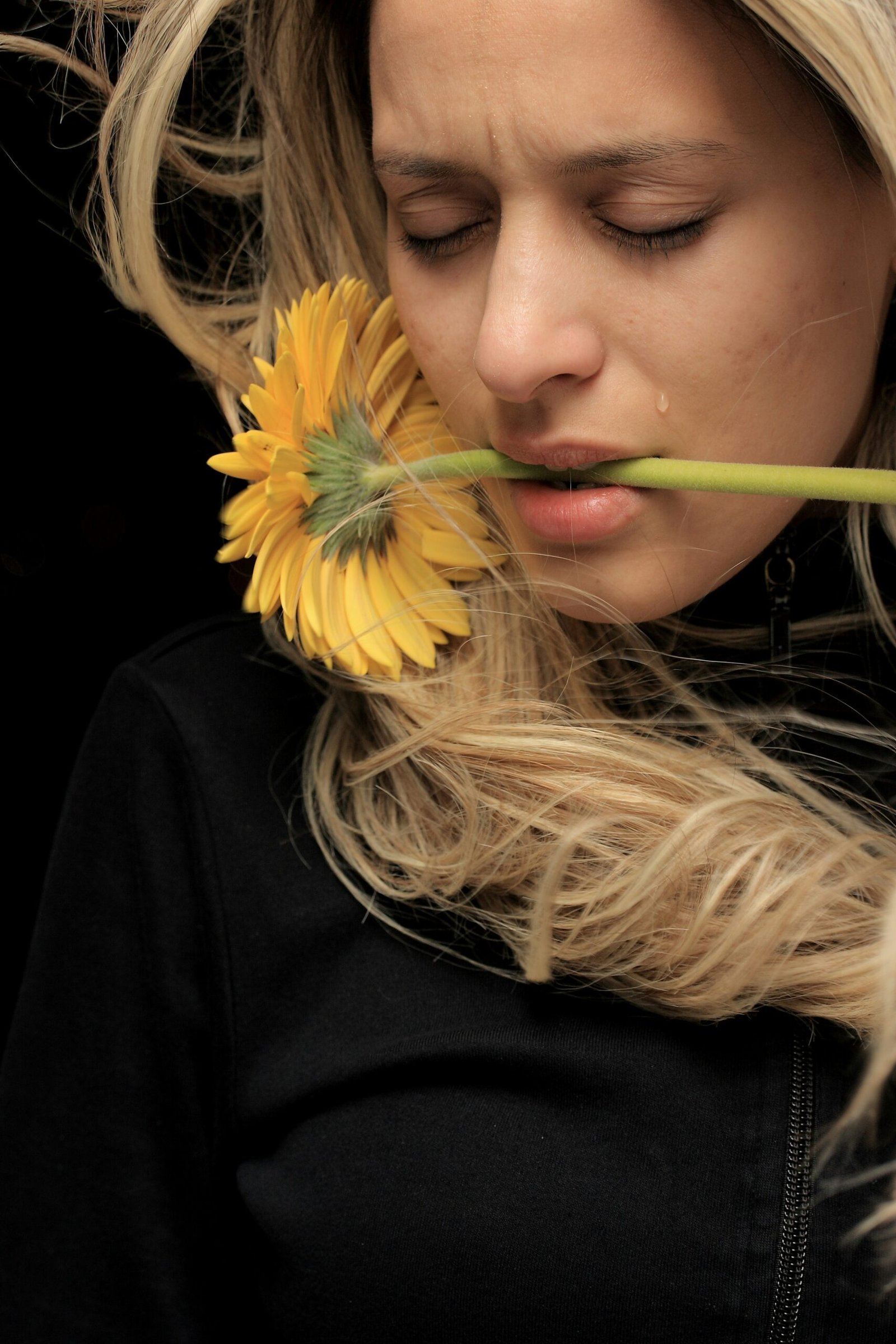 woman in black shirt with yellow hair